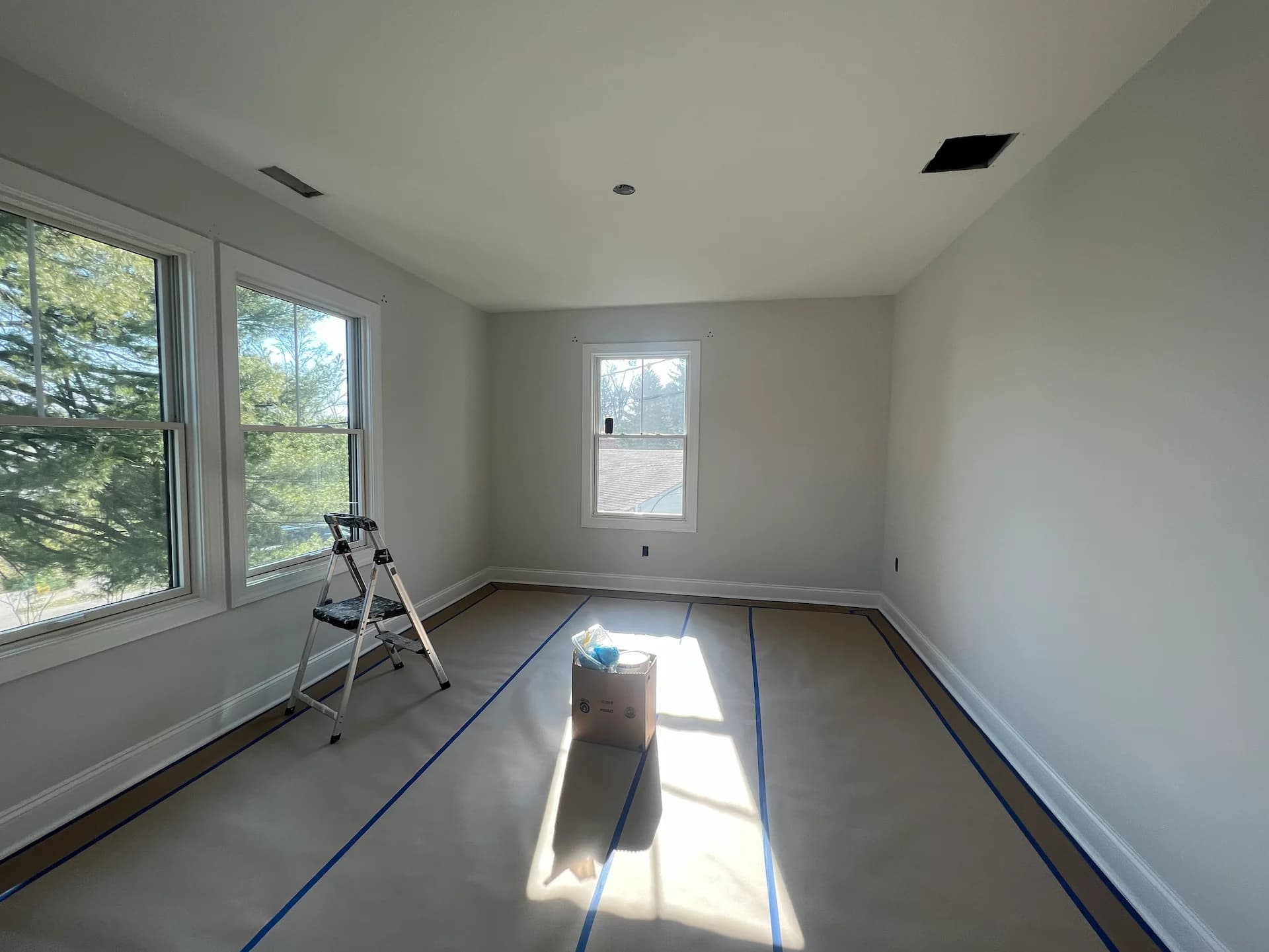 A Happy Home Painter professional carefully preparing a room for painting